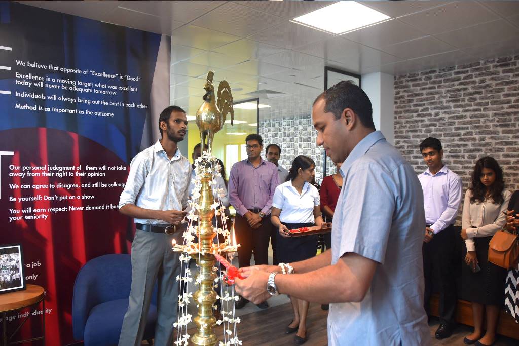 Dr. Kumudu Gunasekera, Director, Stax Inc. lighting the traditional oil lamp