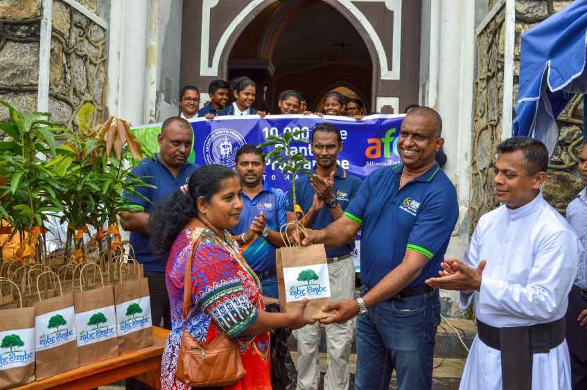 Pic#2 - Mr Michael Benedict, Director – Recoveries AFC, along with Rev. Fr. Damien Arsakularatne handing over plants to the family community (LBN)