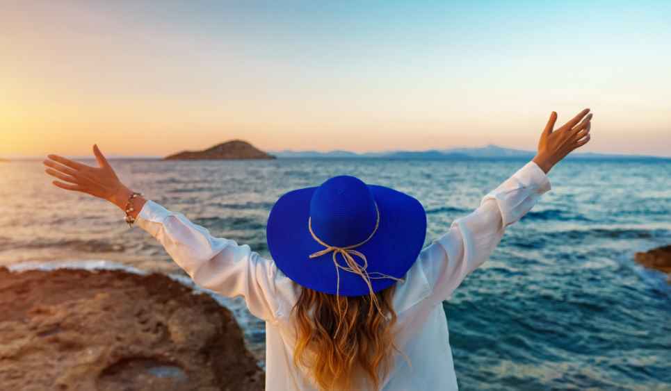 Woman,With,Wide,Arms,Open,At,Sunset,By,The,Sea.